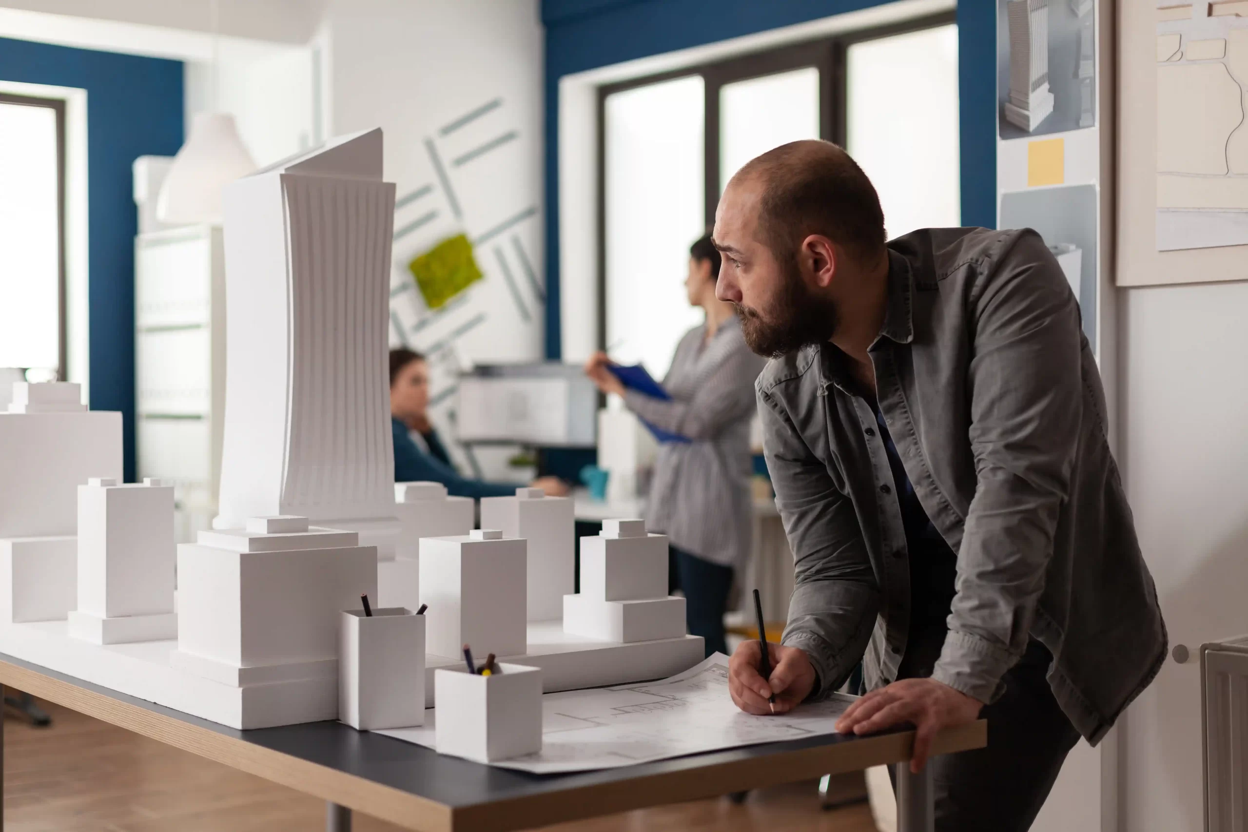 3d architectural model of a tower and a men