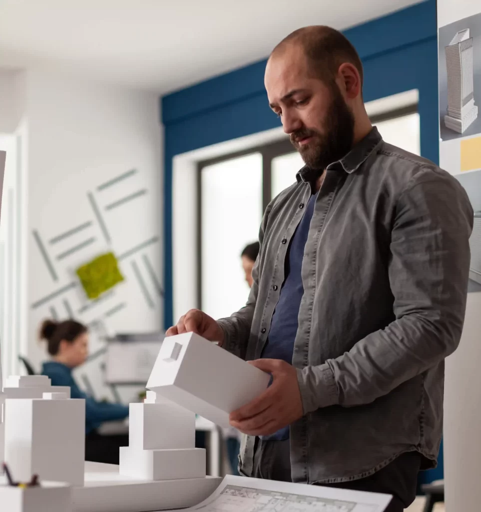 person looking at scaled building model