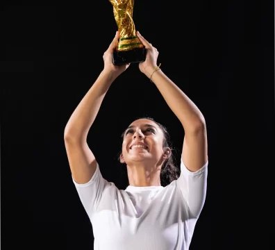 a lady raising a trophy