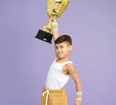 a boy holding a trophy