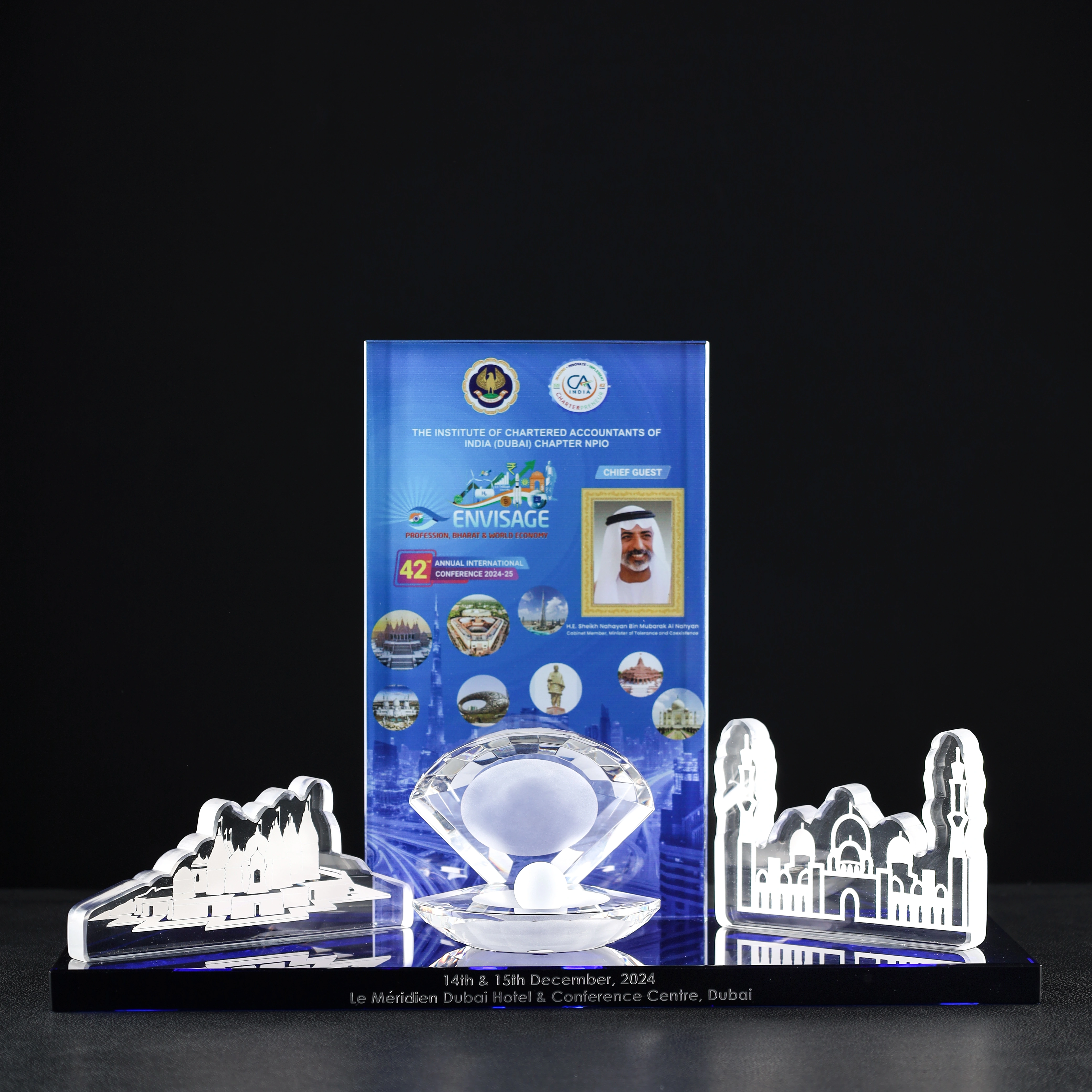 Custom crystal trophy for ICAI Dubai Conference 2024 featuring engraved architectural landmarks and a pearl-shaped centerpiece.