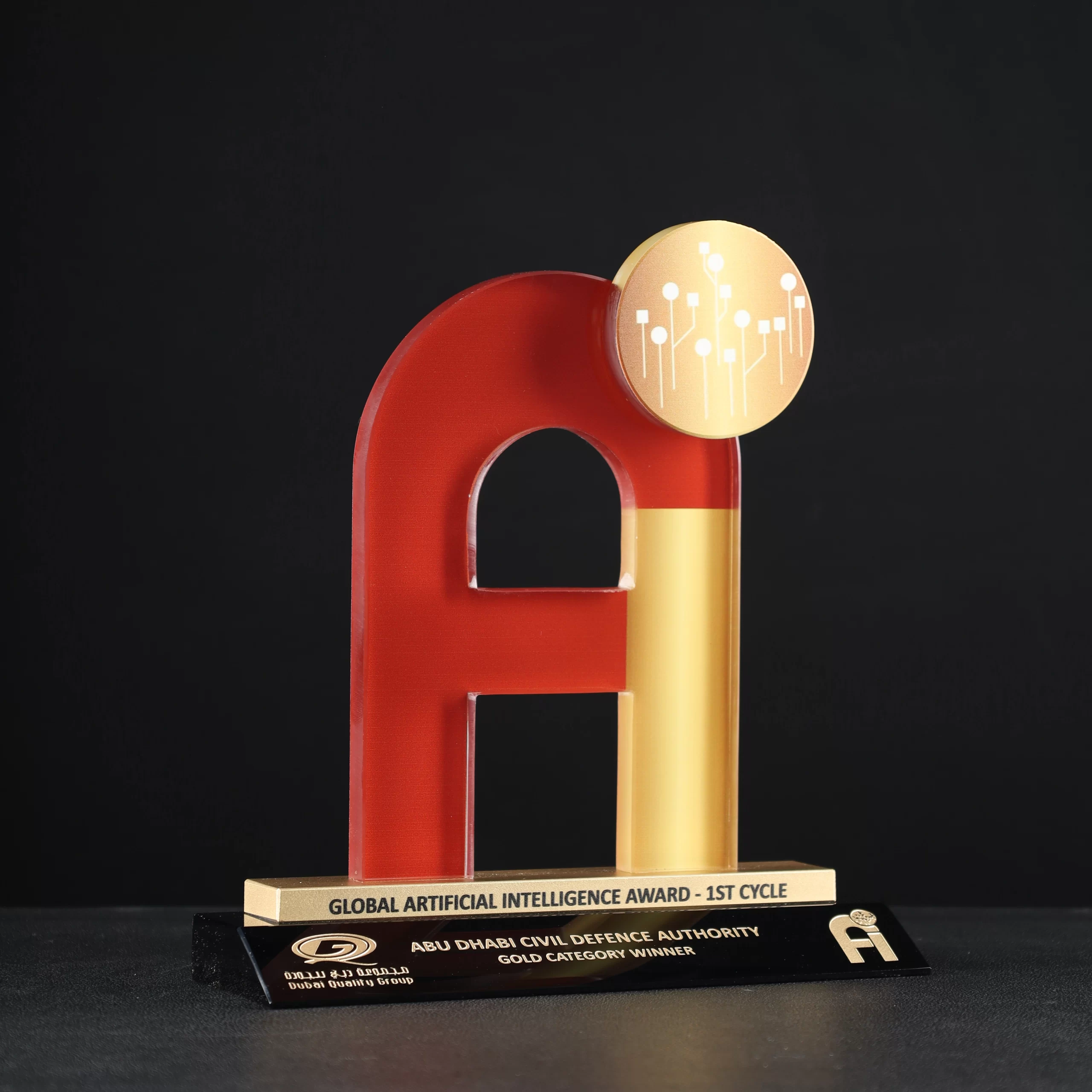 Custom 'Ai'-shaped crystal award with red and golden finish on a black base, designed for the Global Artificial Intelligence Award by Dubai Quality Group.