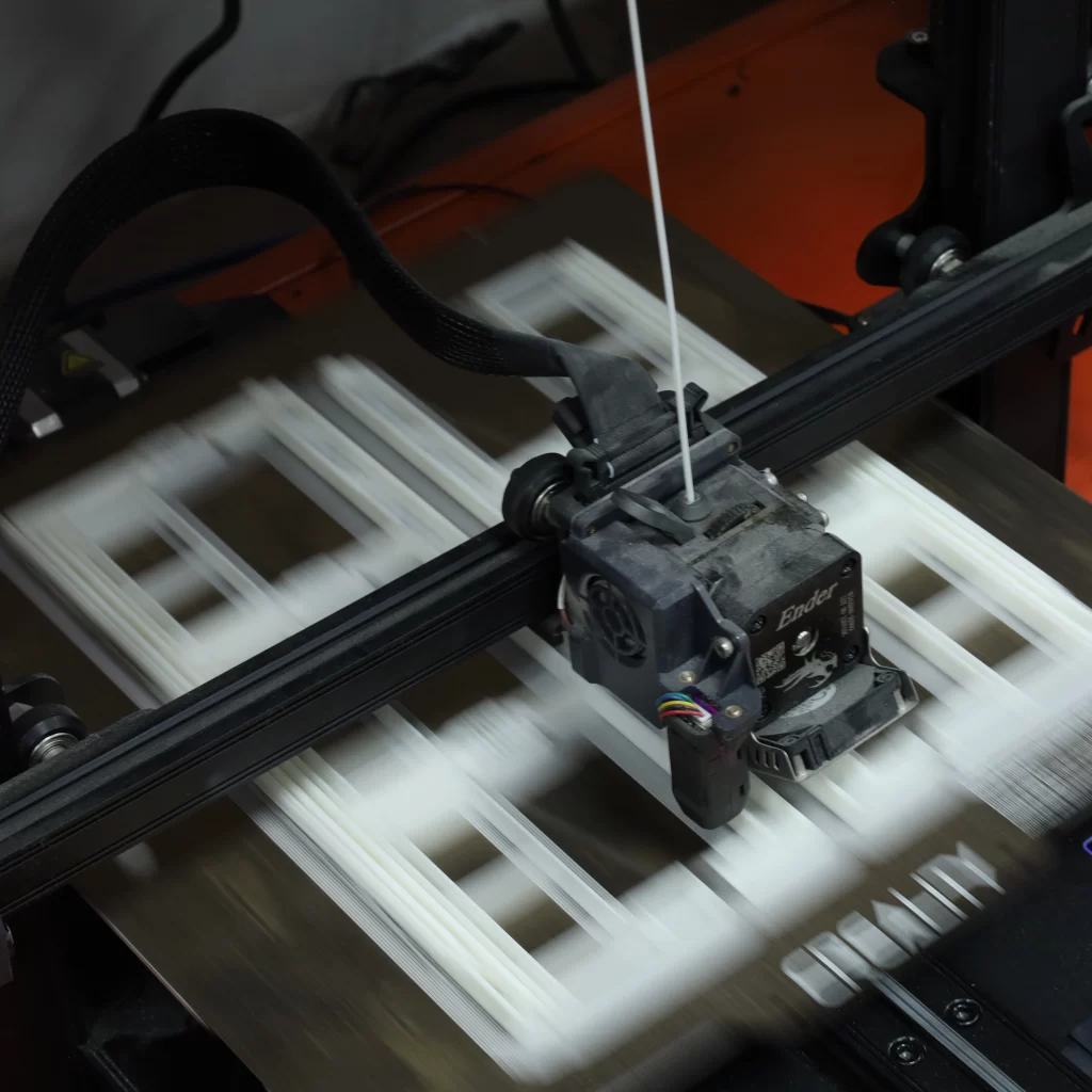 3D printing machine processing a 3D part using PLA filament.